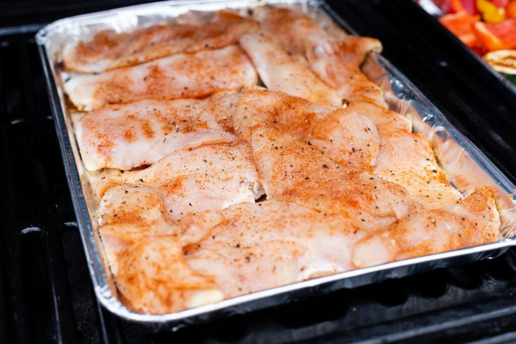 Raw chicken thighs on a tray
